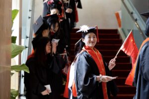 Students in line in the foyer of the theater, waiting to follow the procession into the auditorium