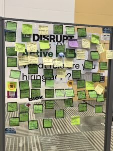 A wall at the conference covered in post it notes from attendees