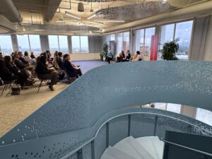 A view of the audience seated listening to the panel Senator Dave Cortese, Dr. Mehrdad Alisgari, Dr. Mary Murphy, and Dawn Carter discussing AI in Silicon Valley