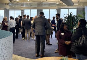Audience members continue talking over coffee after the panel