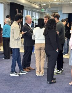 A group of students gather around Senator Cortese after the event to continue the conversation