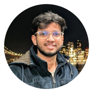 A photograph of Abdullah with a city skyline behind him