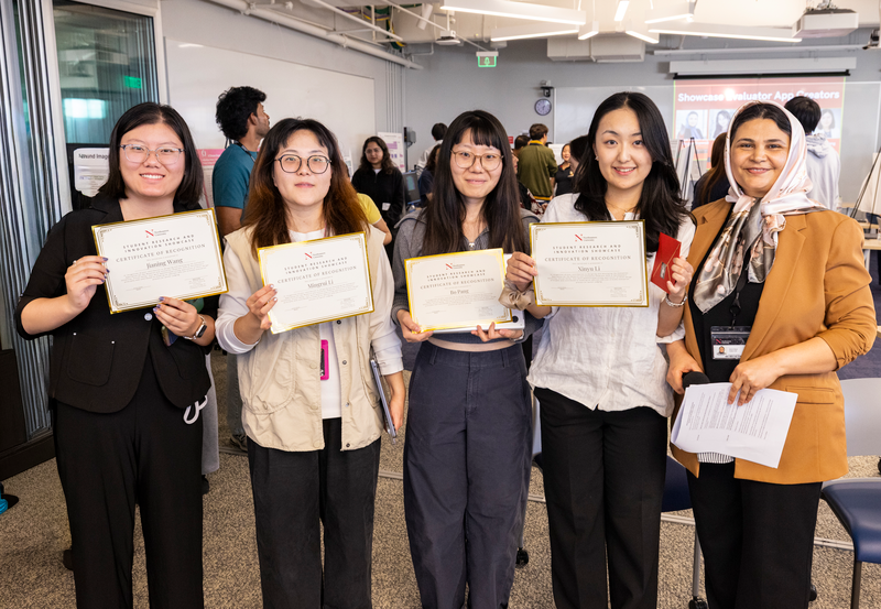 The team that developed the evaluation app pose with their certificates, received in recognition for their work.